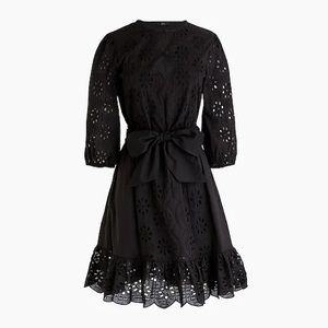 Tie-waist, lined, eyelet dress with scallop hem.